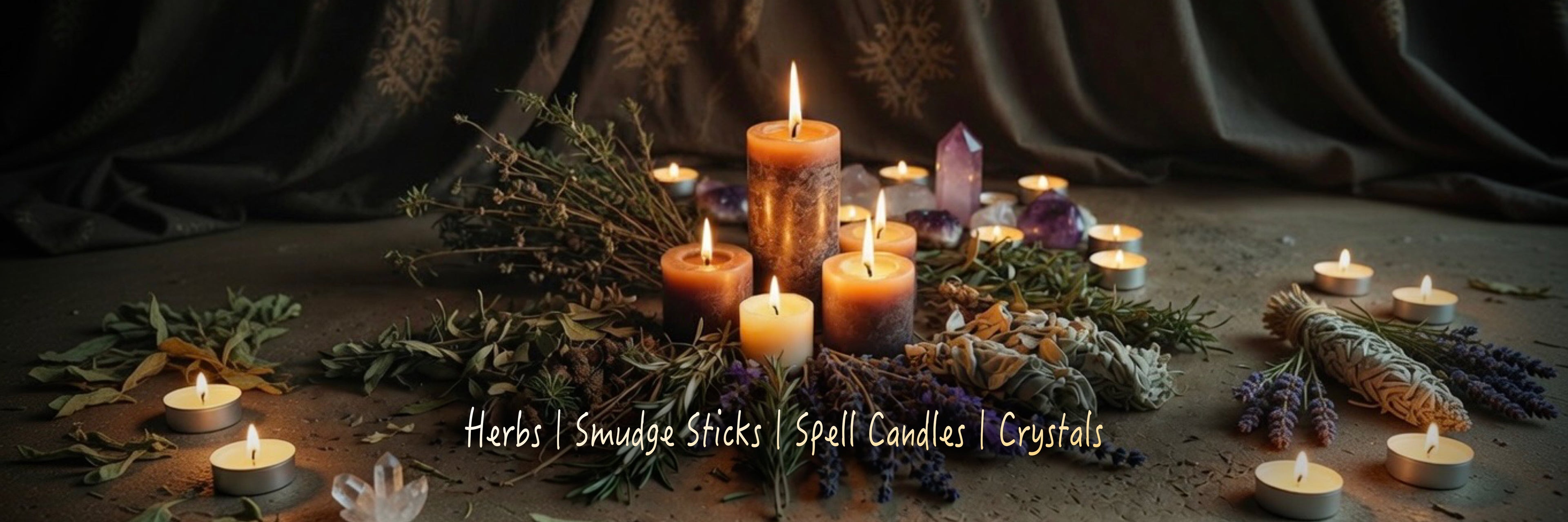 Display of dried herbs arranged around lit spell candles, with crystals against a dark curtained background