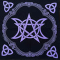 Black altar cloth with purple pentagram and triple moon design on a wooden surface