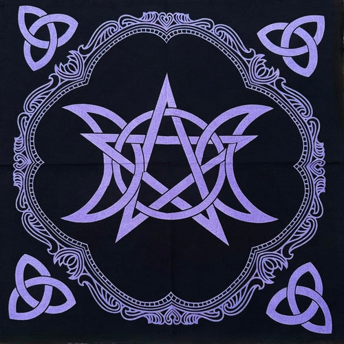 Black altar cloth with purple pentagram and triple moon design on a wooden surface