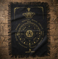 Black cloth with gold mystic moth design on a wooden surface