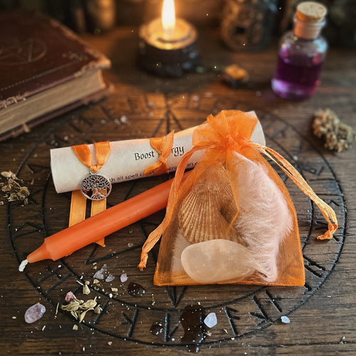 Boost energy spell kit with candle and scroll on carved wood surface with occult symbols
