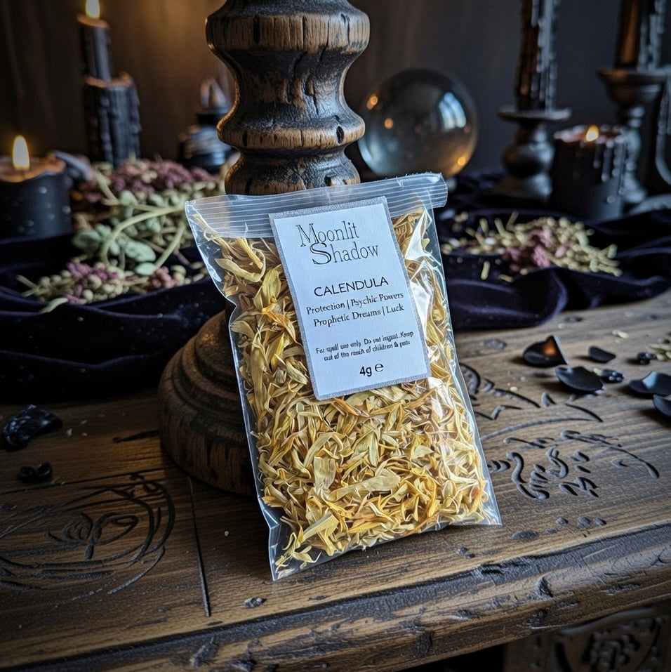 Packaged calendula with 'Moonlit Shadow' label on an occult table setting.