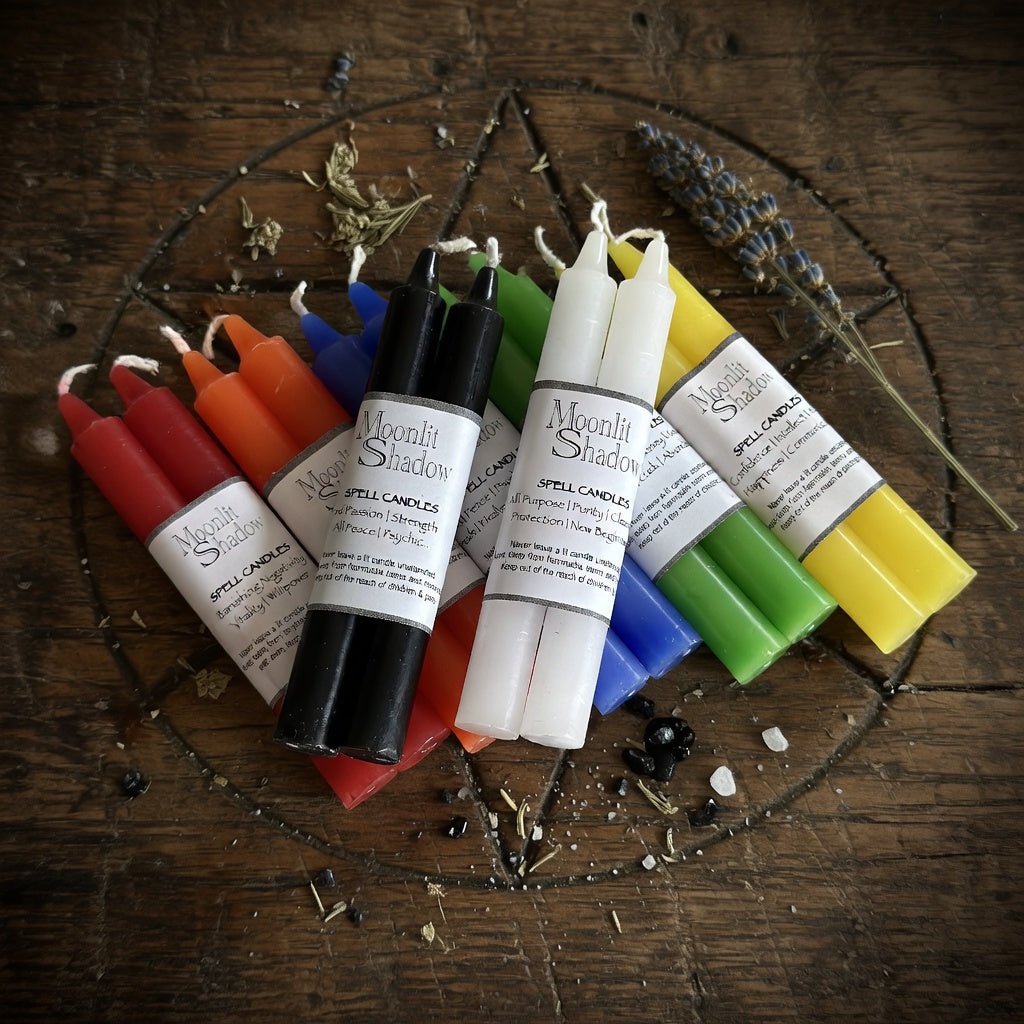 Colorful spell candles with labels on a occult carved wooden surface