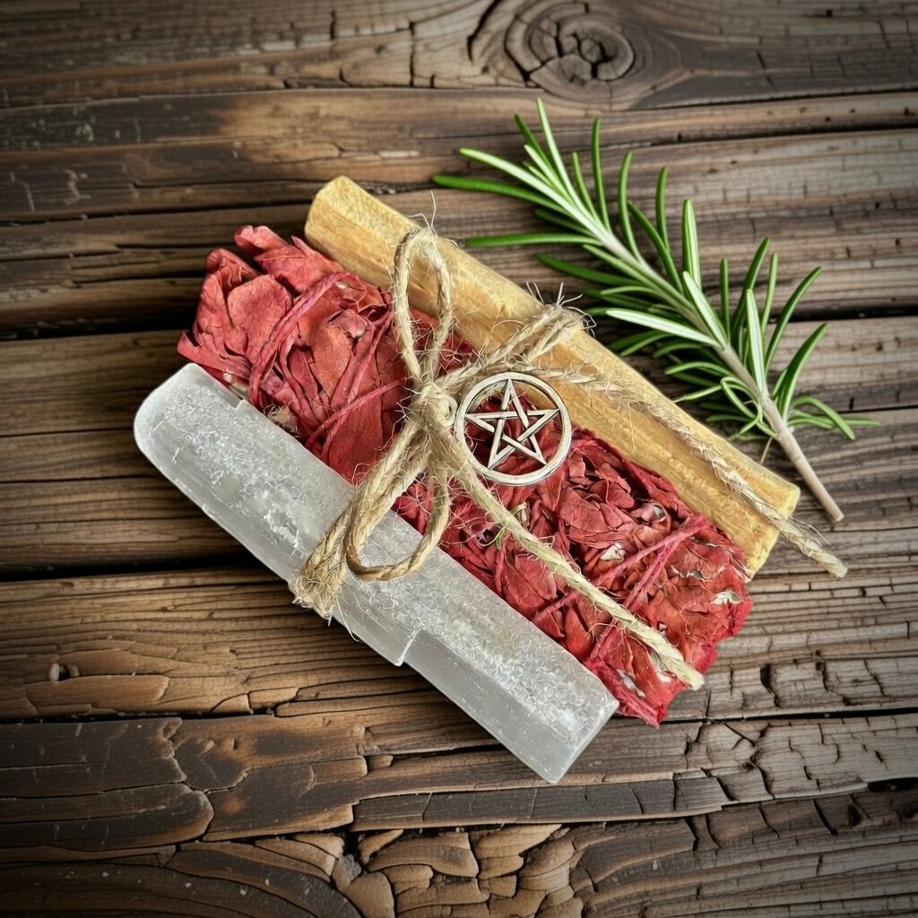 Cleansing bundle with dragon's blood smudge stick, selenite and palo santo, with pentagram symbol on aa aged wooden surface.