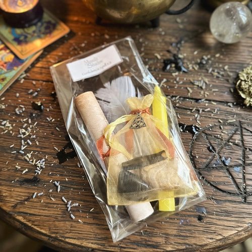 Moonlit Shadow confidence spell kit on an occult themed carved wood surface with herb sprinkles and tarot cards