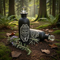 2 decorative black bottles of wolfsbane, with glass stopper, in a natural woodland scene