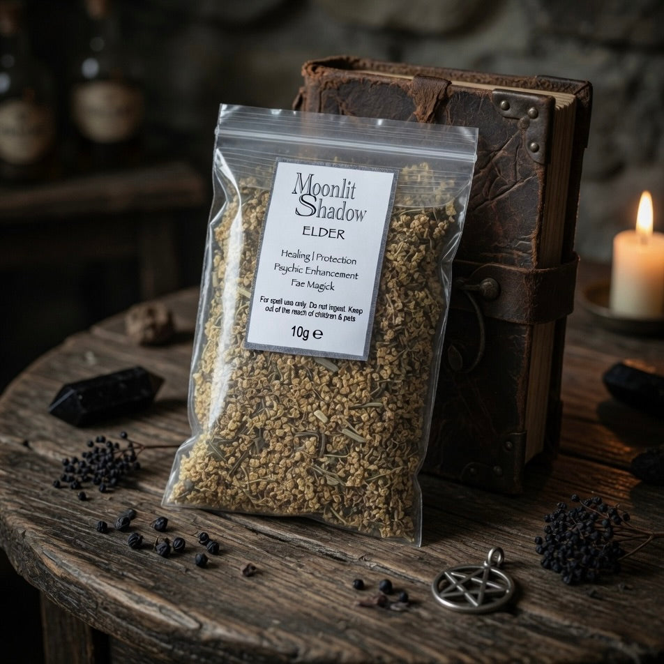 Packaged elder spell herbs with 'Moonlit Shadow' label on a wooden table with witchcraft-themed decor.