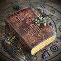 Leather-bound book titled 'The Book of Untold Stories' on an occult carved wooden surface with mystical items.