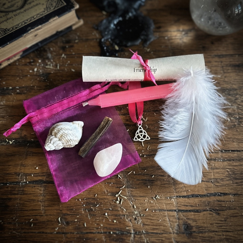 Friendship spell kit contents, organza pouch with shells, feather, and rolled paper on a wooden surface with witchcraft items