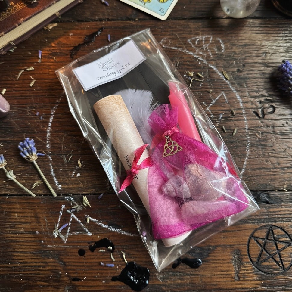 Moonlit Shadow friendship spell kit on a wooden surface with sprinkling of herbs and occult carving