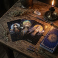 Goddess arcana tarot cards on a wooden table with candles and herbs