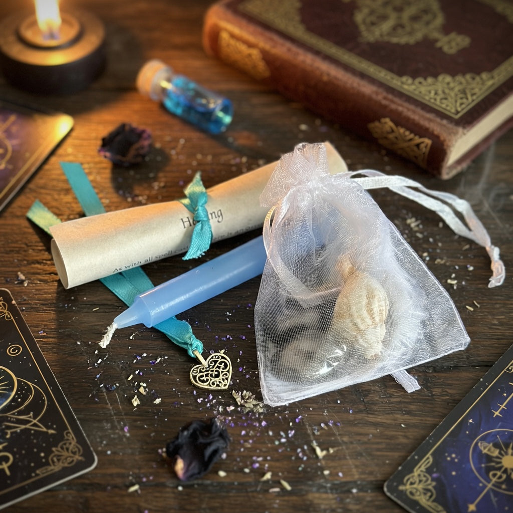 Healing spell kit on a wooden surface with book, tarot cards and candle