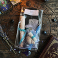 Moonlit Shadow healing spell kit on a carved wooden surface with book, tarot cards and lavender