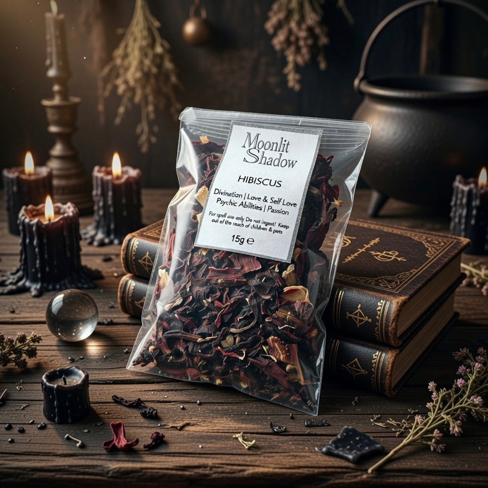Packaged hibiscus spell herbs with a label on a pagan themed setting with candles and books.