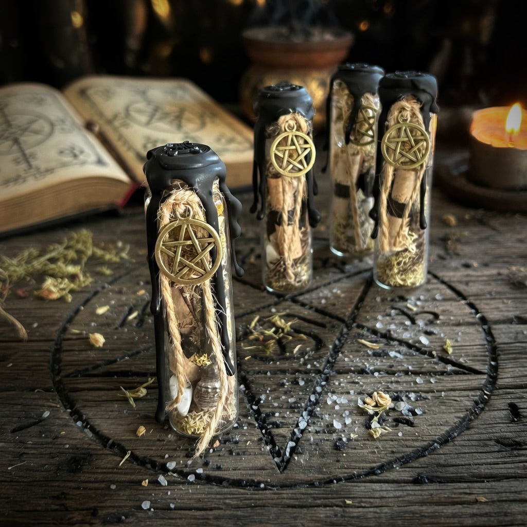 House blessing charm bottle, sealed with wax and a pentagram symbol, on a carved wooden surface with an open book and candles in the background