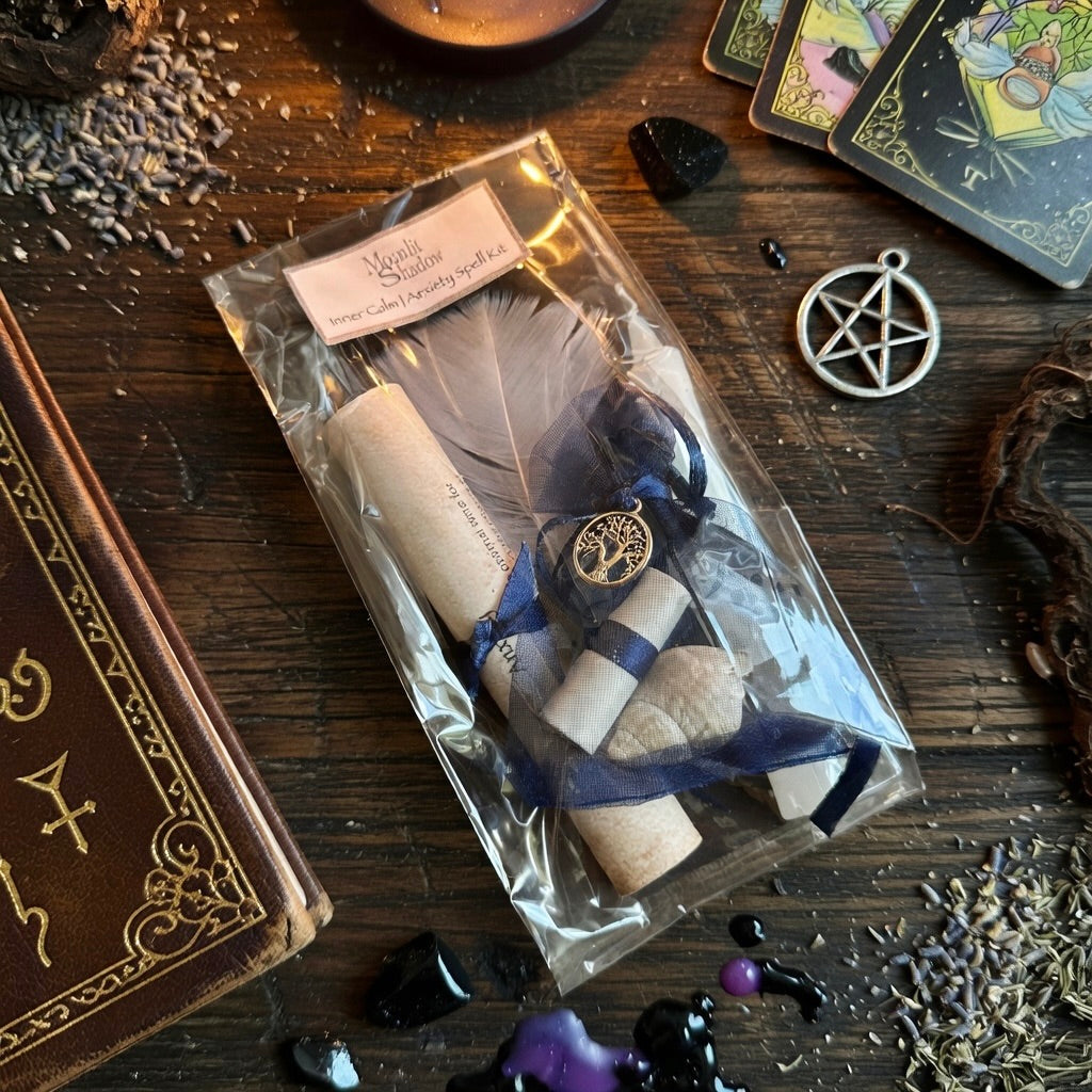 Moonlit Shadow inner calm and anxiety  spell kit on a wooden surface with a  sprinkling of herbs, a book and tarot cards