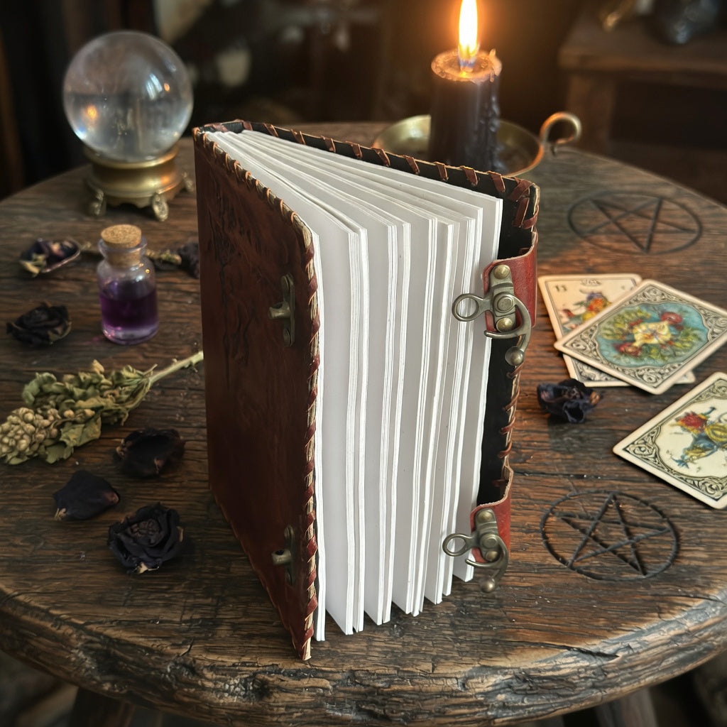 Dream book with tarot cards, candle, and crystal ball on a wooden table