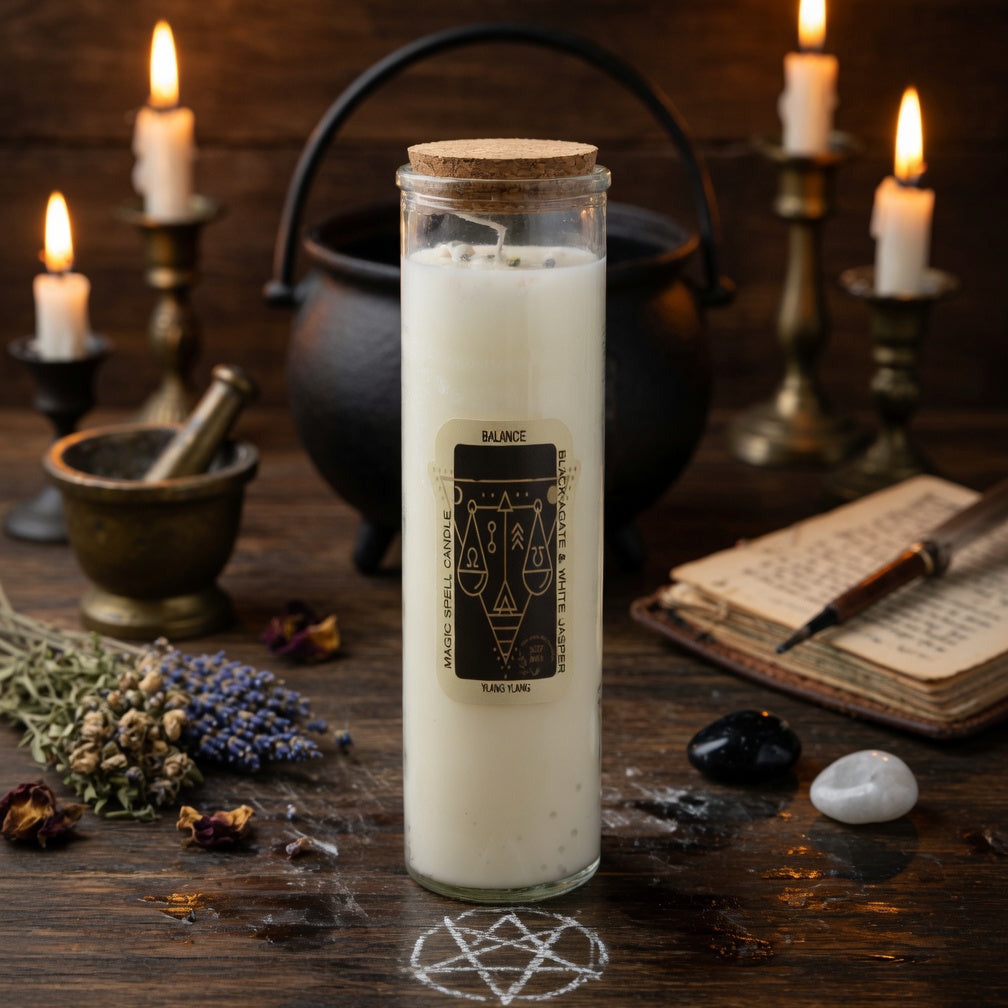 Magic spell candle for balance, with black design on a wooden surface with candles and herbs for sorcery 