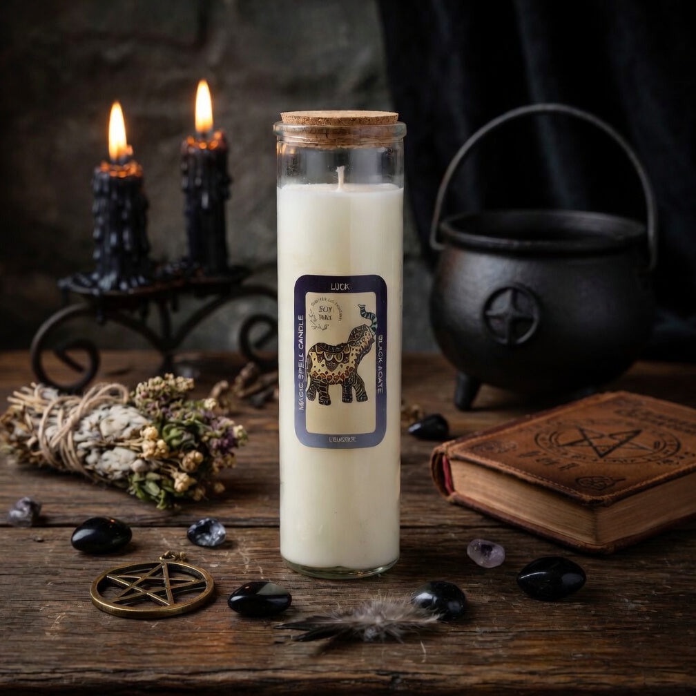 Magic spell candle with a label on a wooden surface with other mystical pagan items