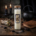 Magic spell candle with a label on a wooden surface with other mystical pagan items