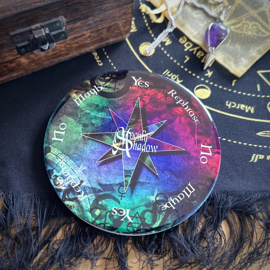 Ceramic moonlit shadow pendulum board with yes/no and maybe options, on a dark fabric background