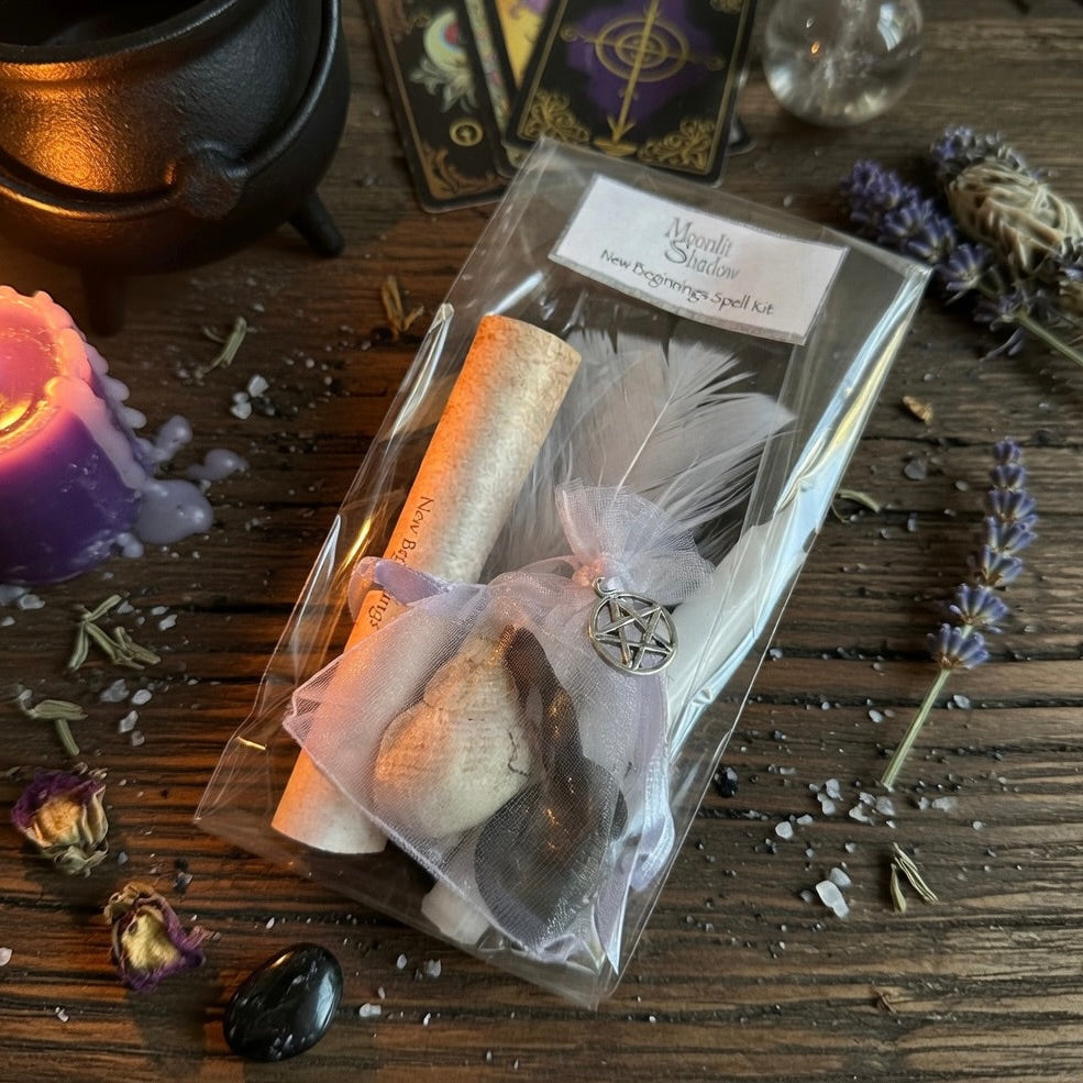 New beginnings spell kit with pentacle charm on a wooden surface with tarot cards