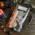 New beginnings spell kit with pentacle charm on a wooden surface with tarot cards