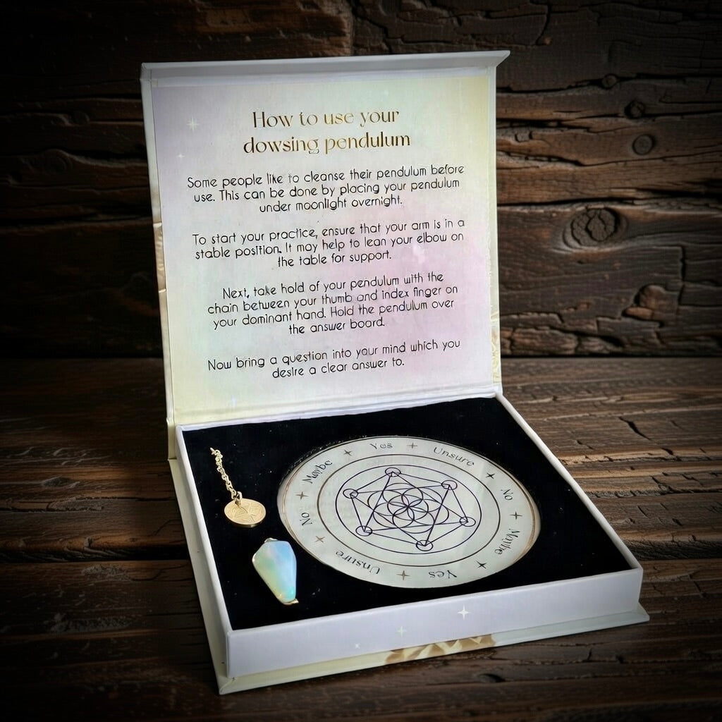 Dowsing pendulum set with instructions in a wooden box on a rustic wooden background