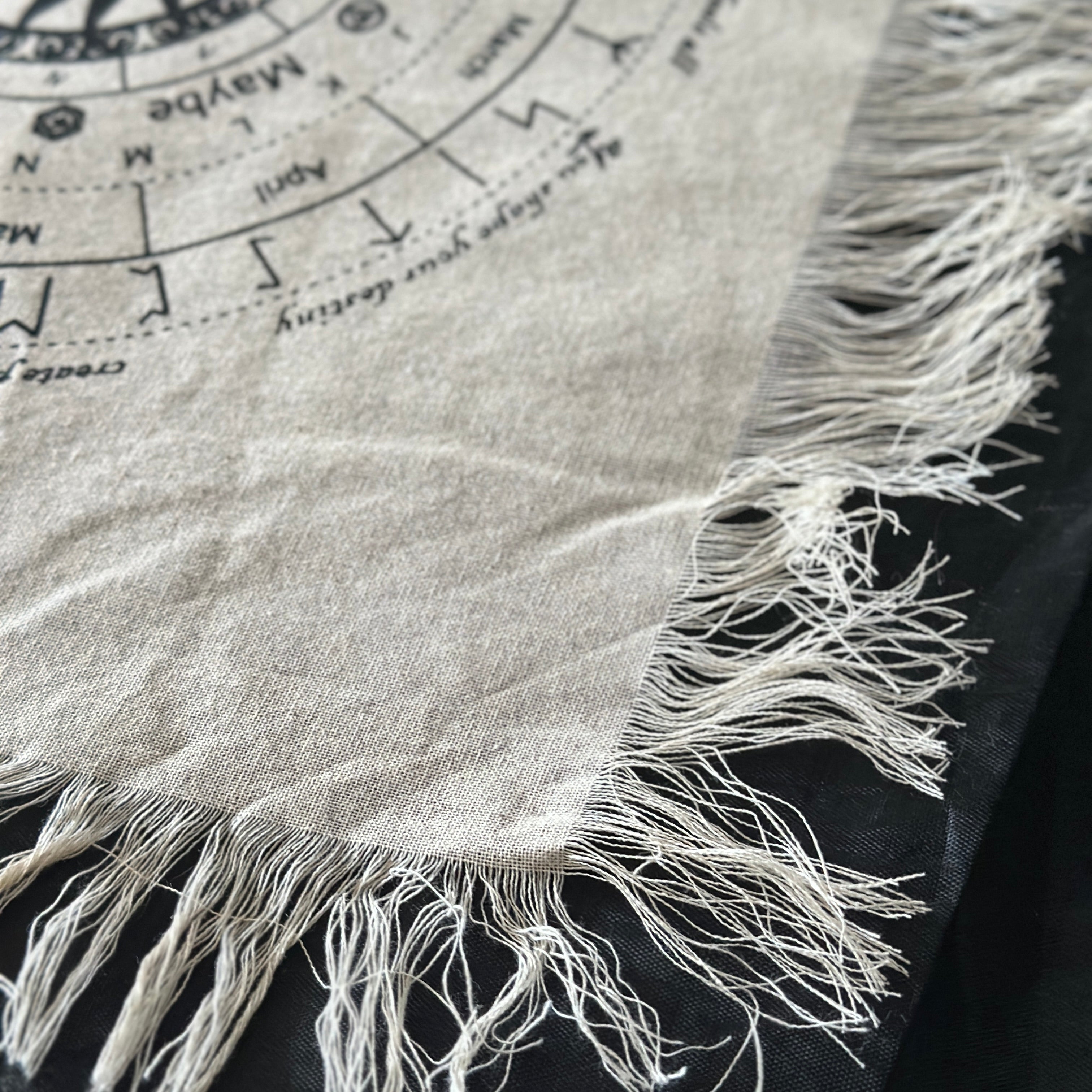 Pendulum divination cloth fringing on a black background
