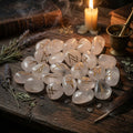 Set of crystal stones with rune symbols on a wooden surface with candles and herbs.
