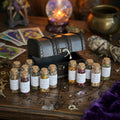 Spell herb gift set, with 13 glass corked herb bottles, including chamomile, hibiscus, nettle and st john's wort, on a, occult carved wooden surface with witchcraft items behind